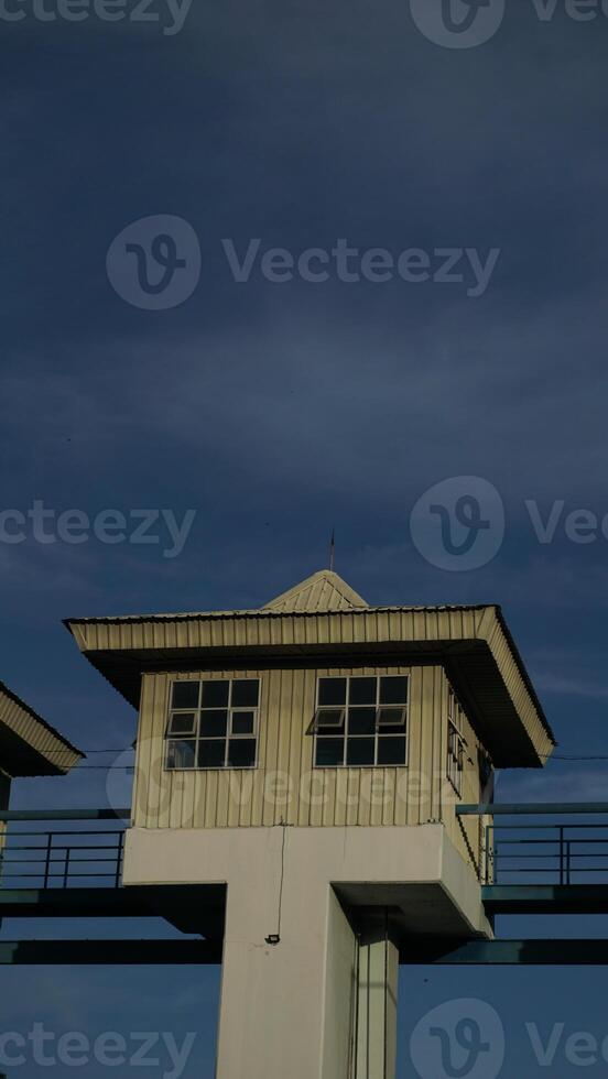 Buildings on top of a water storage dam, vertical photo of dam