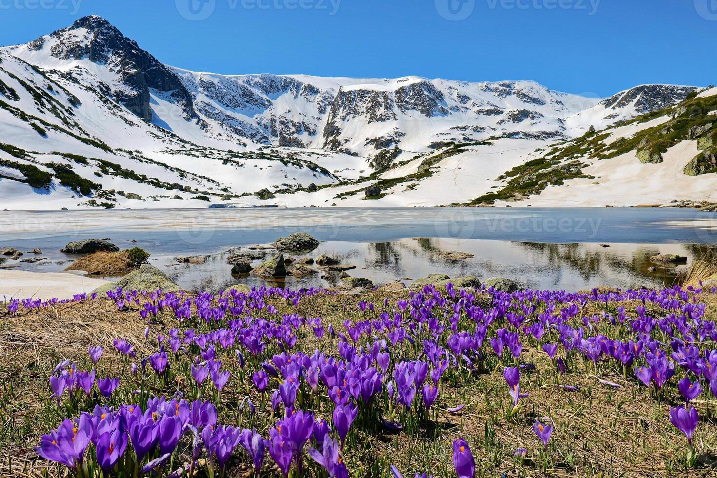 Hike to the Seven Rila lakes, located high in the Rila mountains in Bulgaria. The most visited natural site in the country. Springtime with snow remaining in the mountains. photo