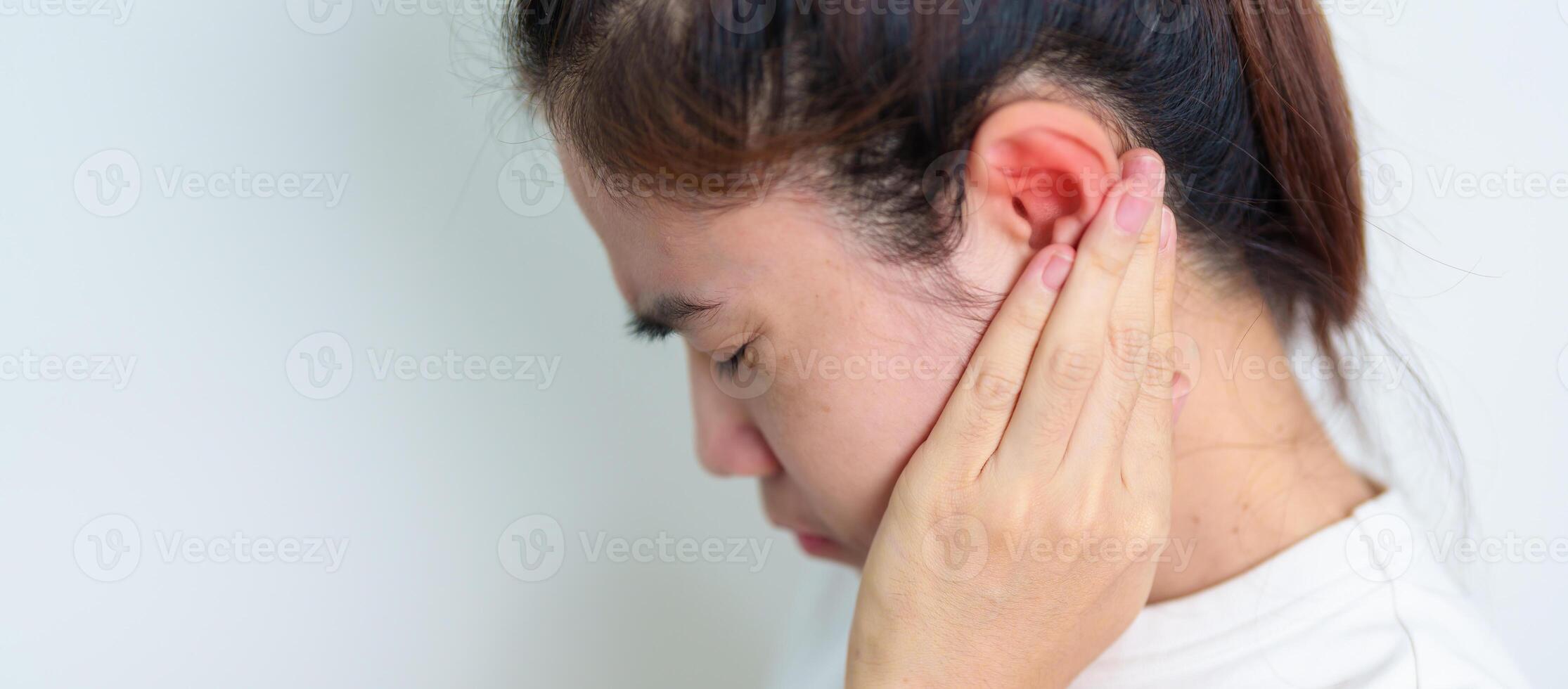 Woman holding her painful Ear. Ear disease, Atresia, Otitis Media, Inflation, Pertorated Eardrum, Meniere syndrome, otolaryngologist, Ageing Hearing Loss and Health concept photo