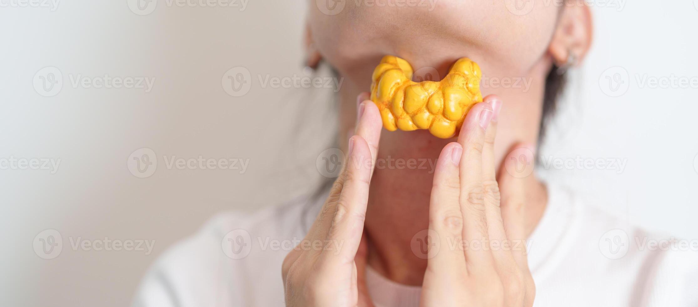 Woman holding human Thyroid anatomy model with her Neck. Hyperthyroidism, Hypothyroidism, Hashimoto Thyroiditis, Thyroid Tumor and Cancer, Postpartum, Papillary Carcinoma and Health concept photo