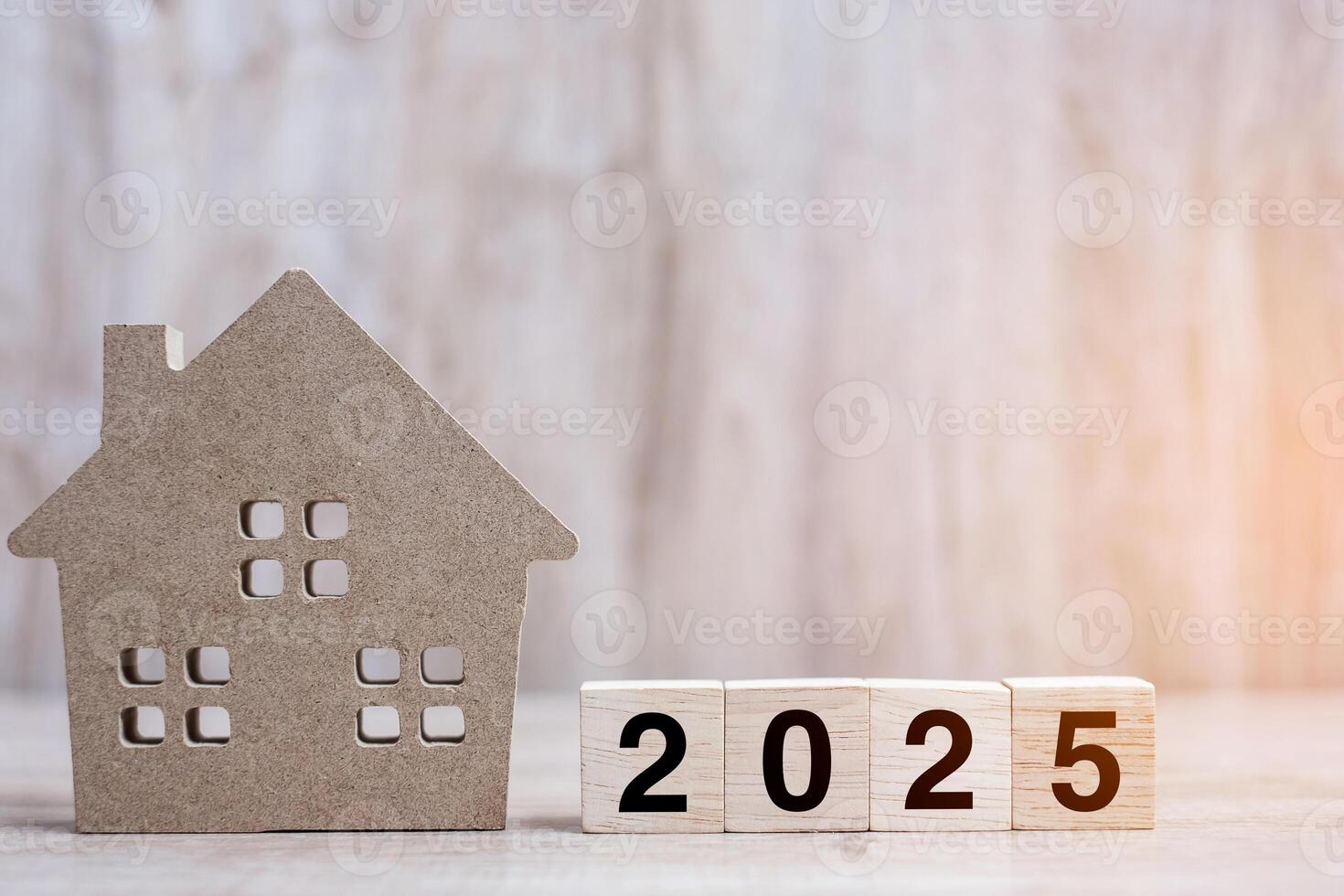 2025 Happy New Year with house model on table wooden background. Banking, real estate, investment, financial, savings and New Year Resolution concepts photo