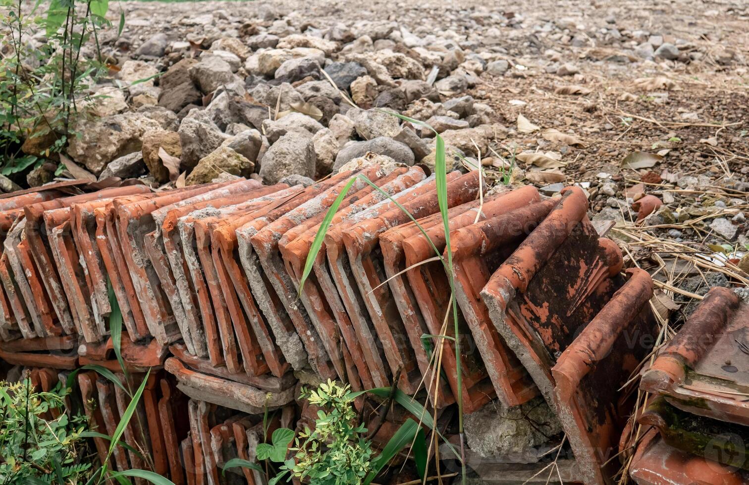 roof tiles arranged to form a fence dividing the land photo