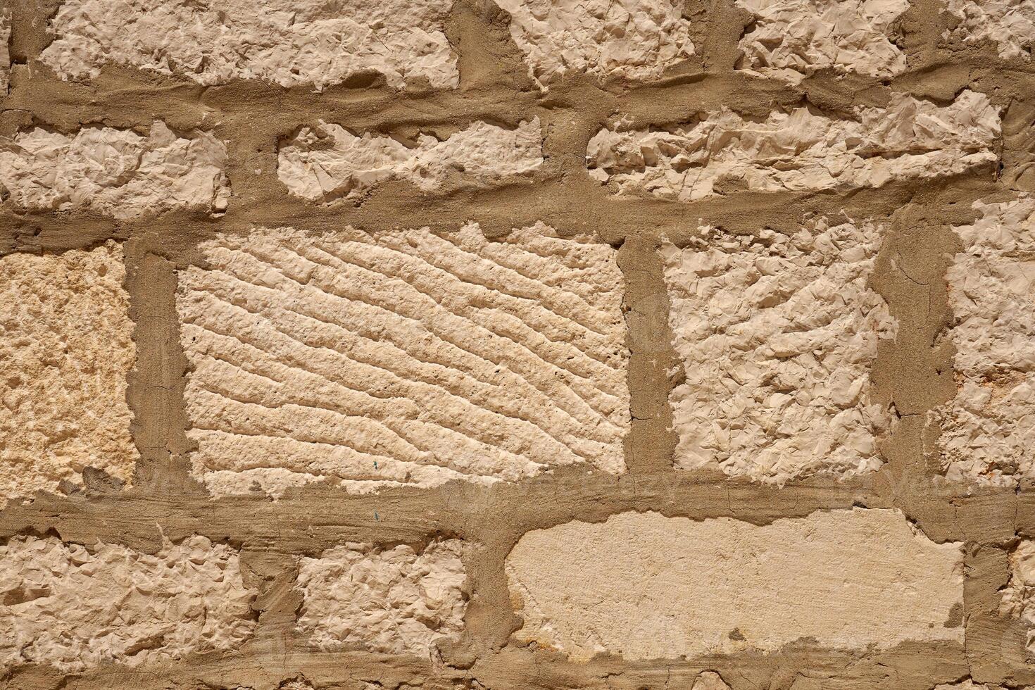A wall of stones on mortar as a background. photo