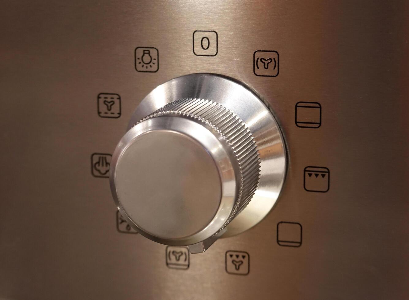 close-up rotary switch to choose a program for the Kitchen oven. Stove in stainless steel. photo
