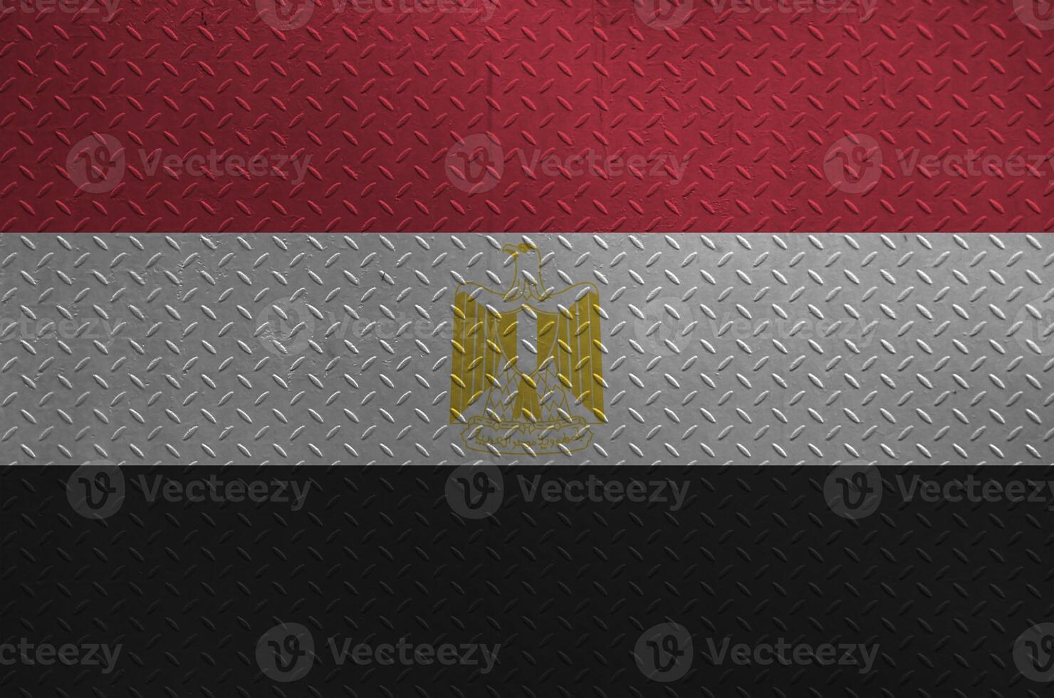 Egypt flag depicted in paint colors on old brushed metal plate or wall closeup. Textured banner on rough background photo