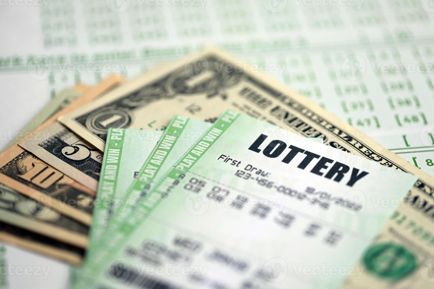 Green lottery tickets and US money bills on blank with numbers for playing lottery photo