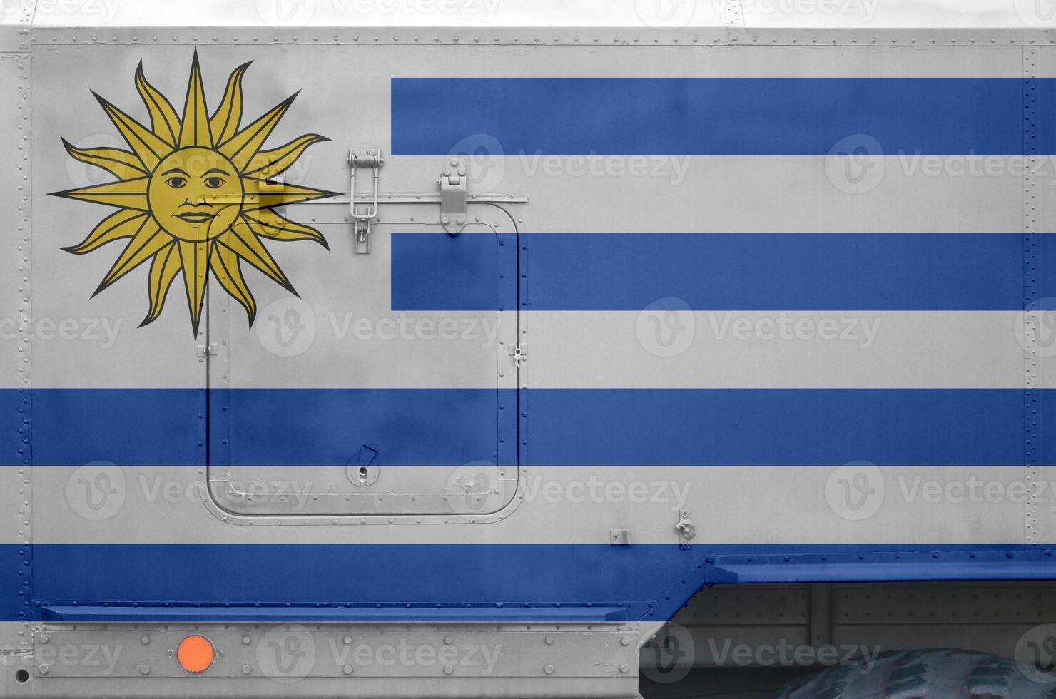 Uruguay flag depicted on side part of military armored truck closeup. Army forces conceptual background photo