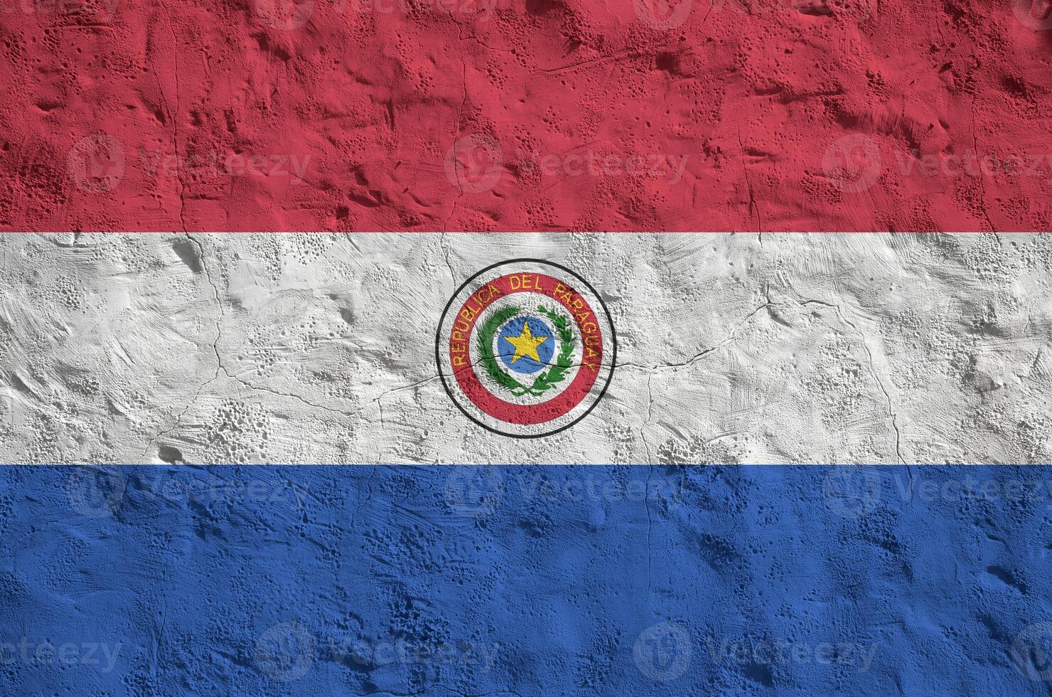 Paraguay flag depicted in bright paint colors on old relief plastering wall. Textured banner on rough background photo