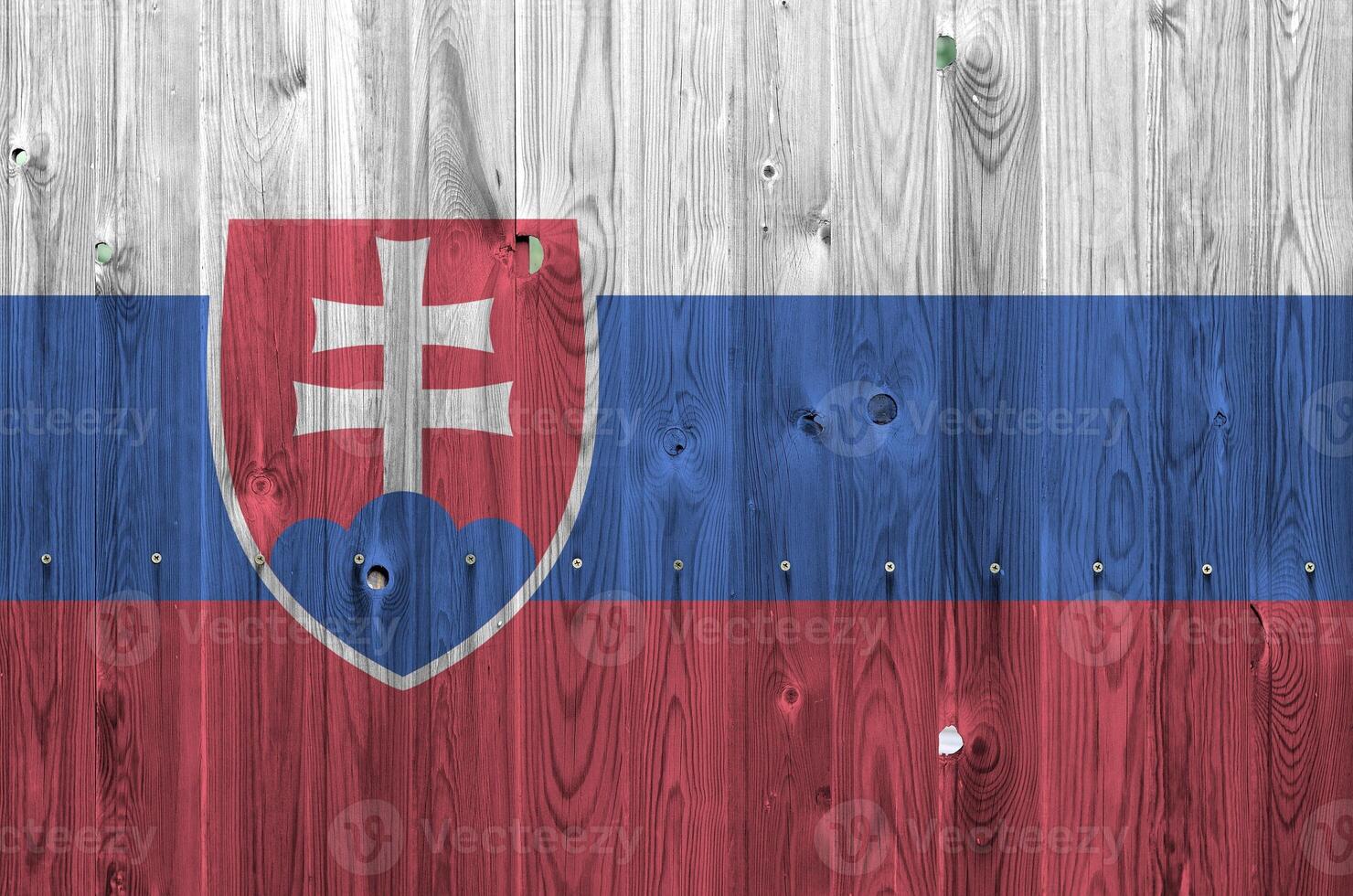 Slovakia flag depicted in bright paint colors on old wooden wall. Textured banner on rough background photo