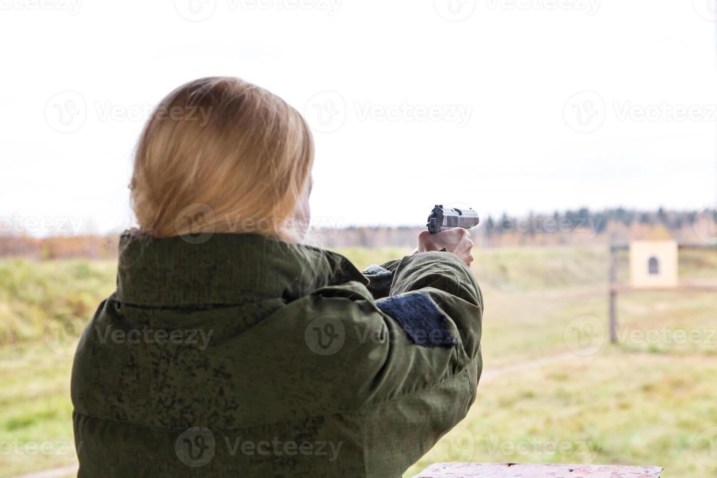 Man shooting at a target. Unformal shooting range photo