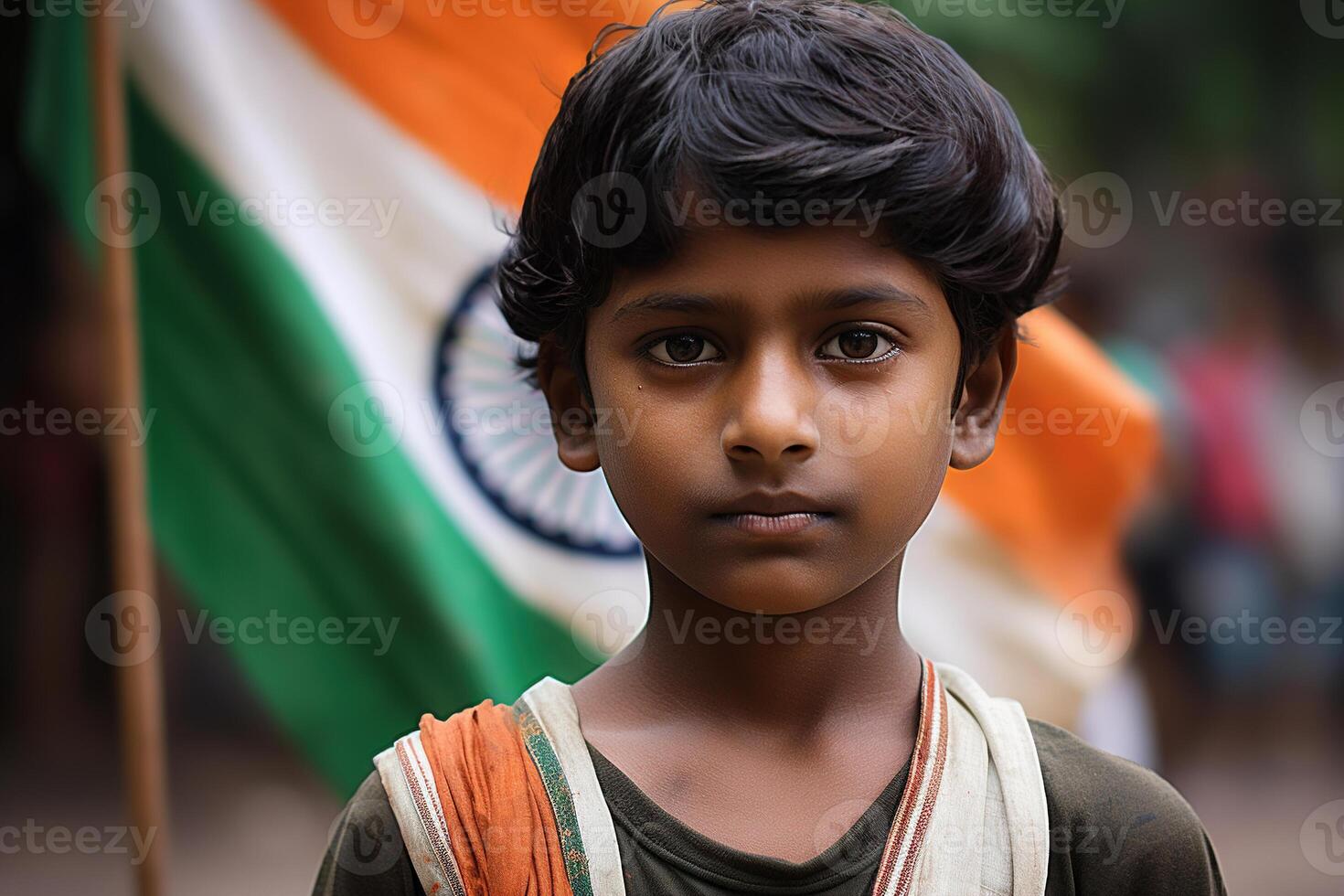 Young Indian boy stands in front of a blurred Indian flag, symbolizing patriotism and national pride. Celebrating Indian Independence Day. Love for the country. photo