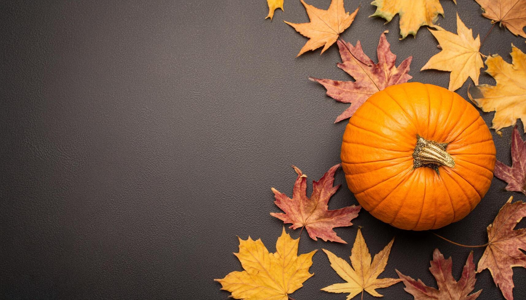 Halloween and Autumn decoration concept made from autumn leaves and pumpkin photo