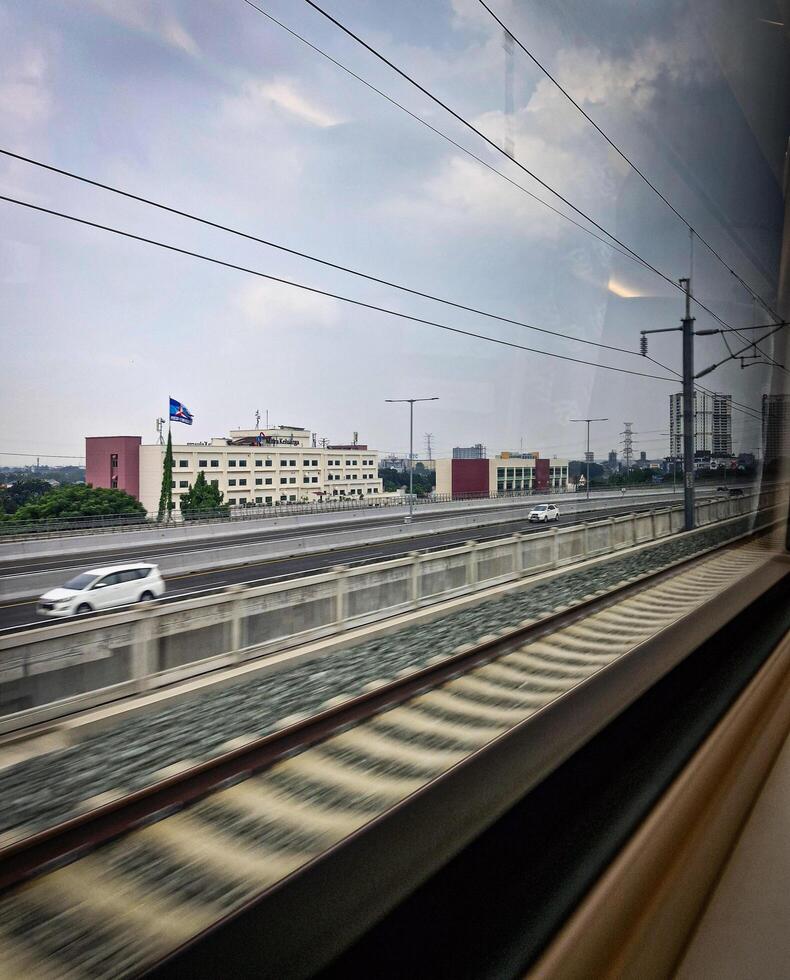 From inside the KCIC Jakarta - Bandung express train, Indonesia as it passes through the elevated highway and through the city. photo
