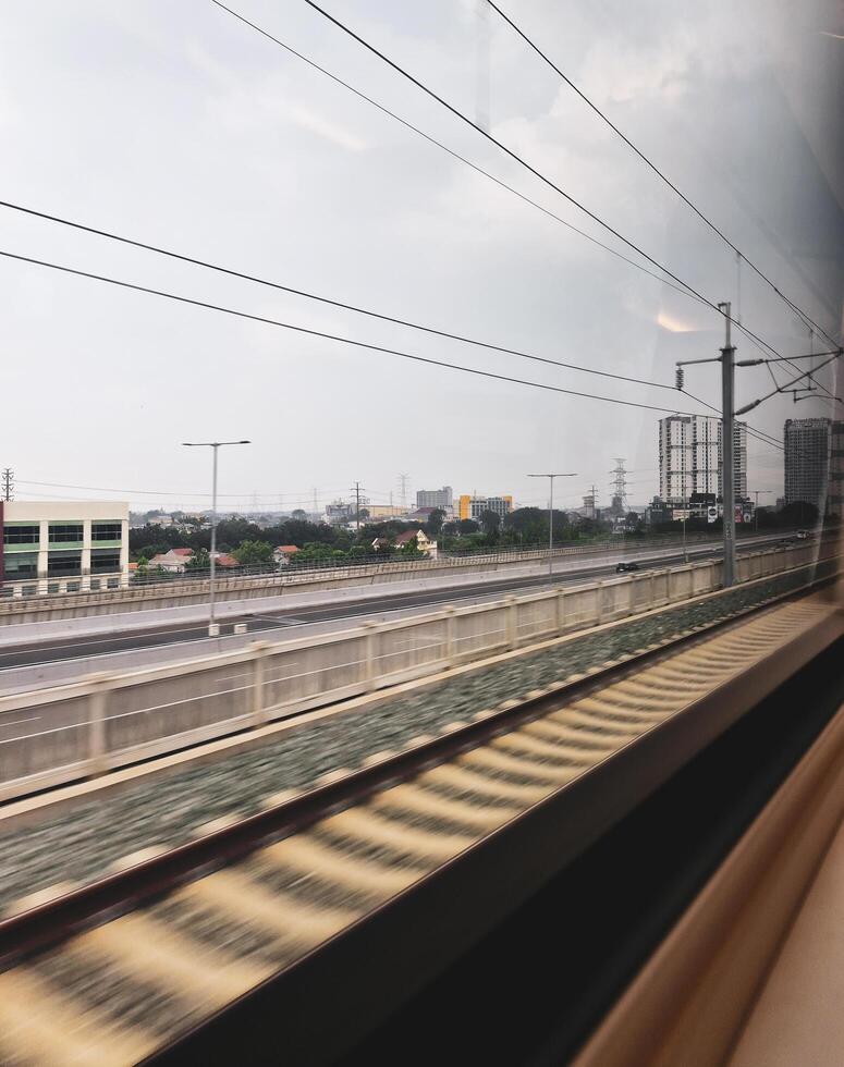 From inside the KCIC Jakarta - Bandung express train, Indonesia as it passes through the elevated highway and through the city. photo