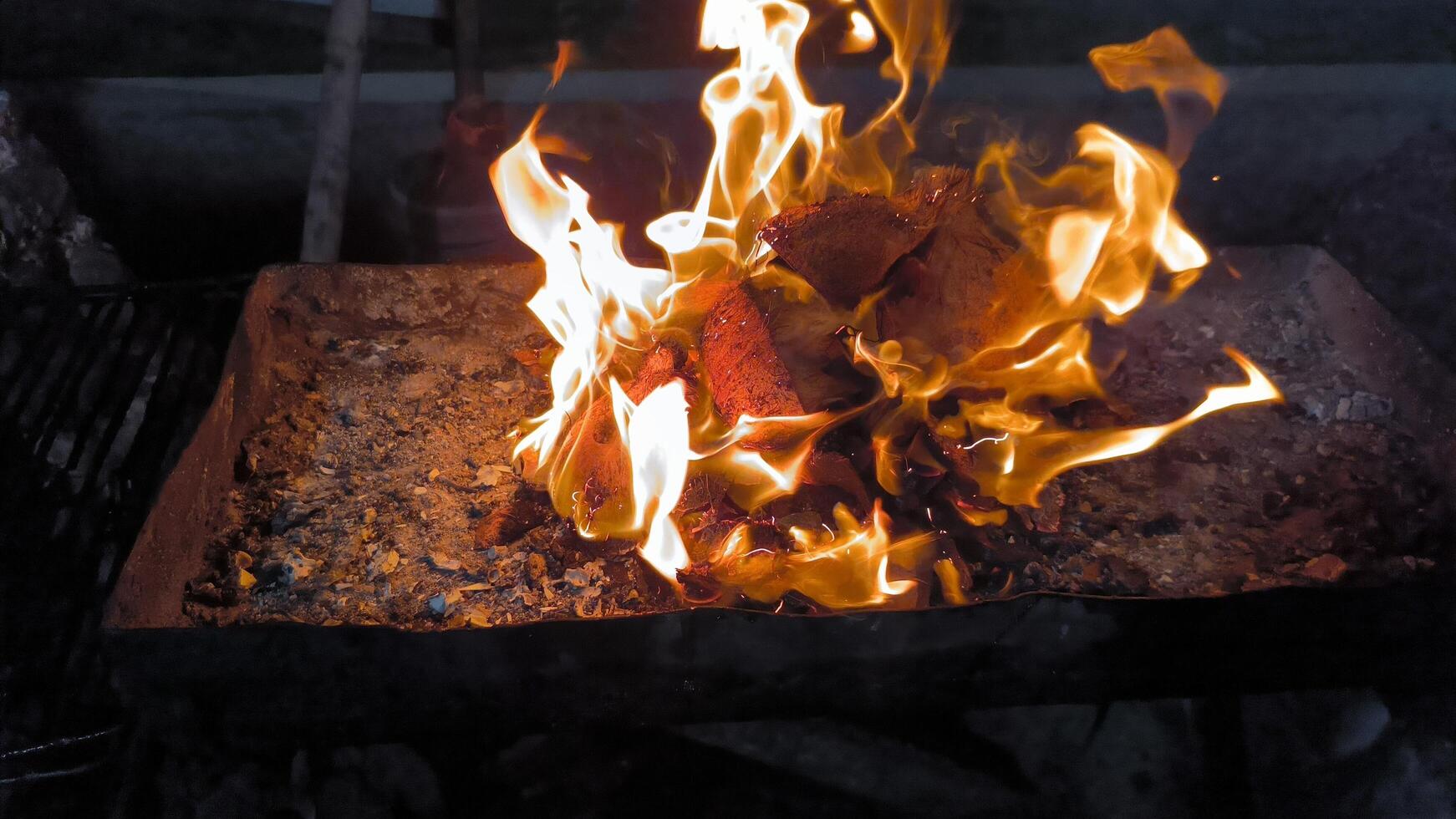 The process of making coals for grilled fish, made from old coconut shells photo
