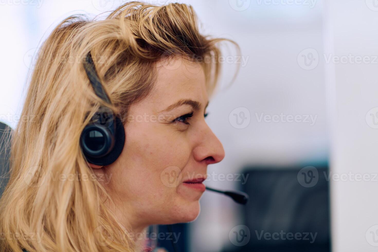 Friendly Call Center Agent Answering Incoming Calls with Headset Providing Remote Customer Service. photo