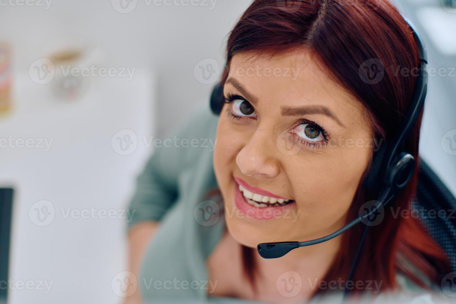 Friendly Call Center Agent Answering Incoming Calls with Headset Providing Remote Customer Service. photo