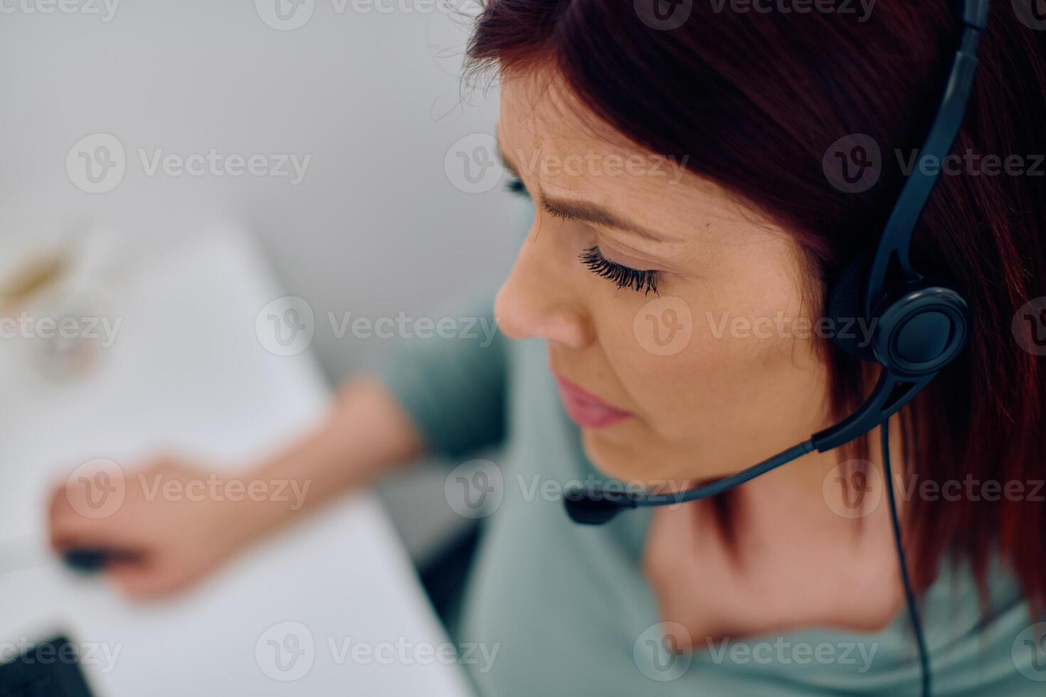 Friendly Call Center Agent Answering Incoming Calls with Headset Providing Remote Customer Service. photo