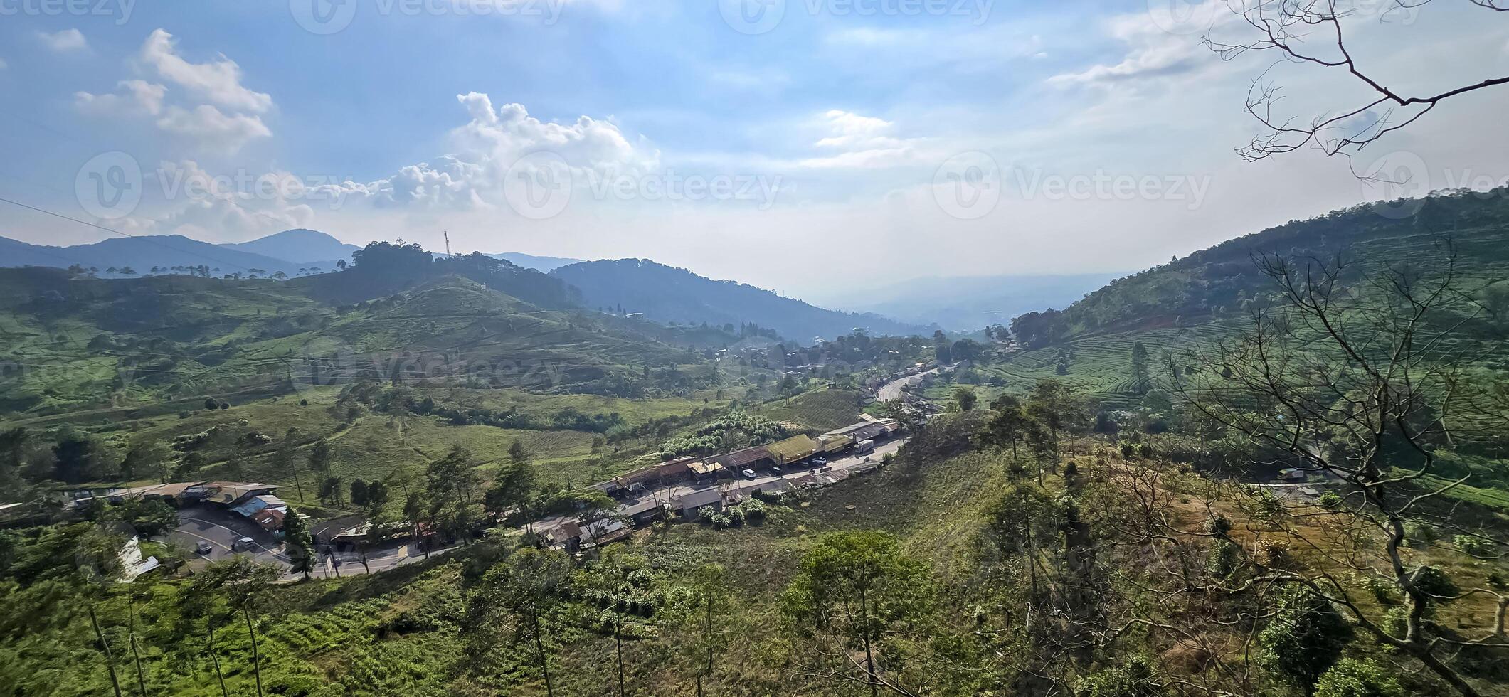 Beautiful scenery on top of hill, green view and blue sky with clouds, location at puncak pass, bogor, indonesia photo