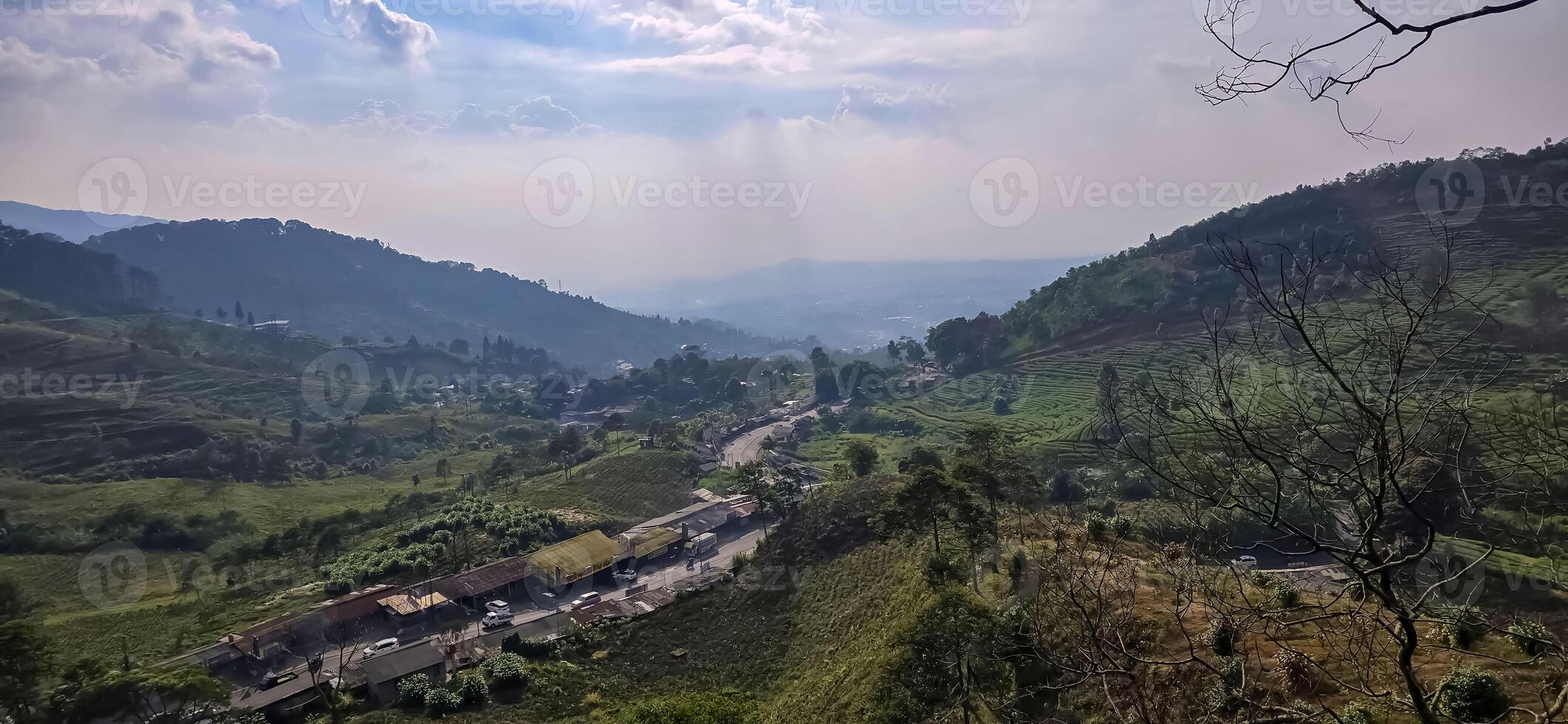 Beautiful scenery on top of hill, green view and blue sky with clouds, location at puncak pass, bogor, indonesia photo