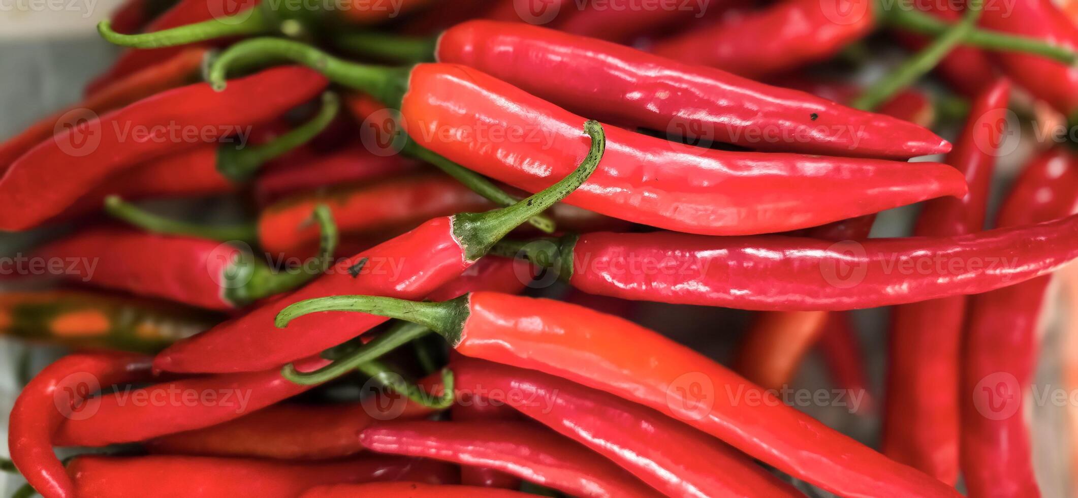 Red hot chilli peppers texture background, close up, A backdrop of Red hot chilli peppers, Street vegetable market, Group of Red hot chilli peppers photo