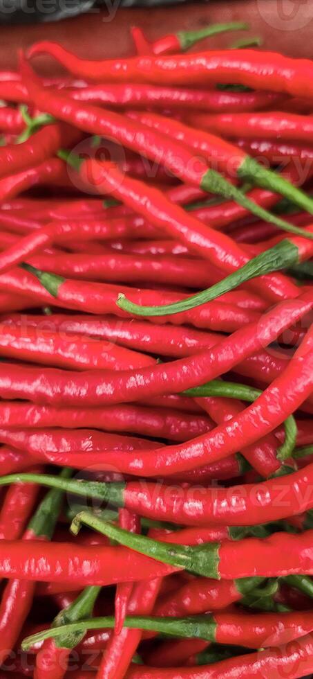 Red hot chilli peppers texture background, close up, A backdrop of Red hot chilli peppers, Street vegetable market, Group of Red hot chilli peppers photo
