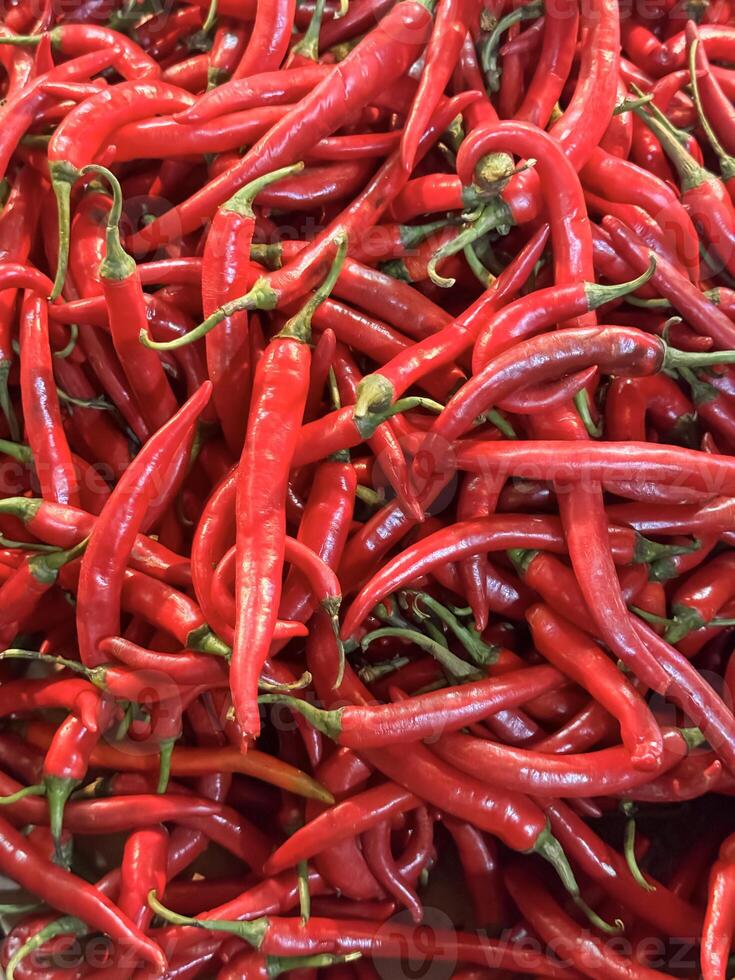 Red hot chilli peppers texture background, close up, A backdrop of Red hot chilli peppers, Street vegetable market, Group of Red hot chilli peppers photo