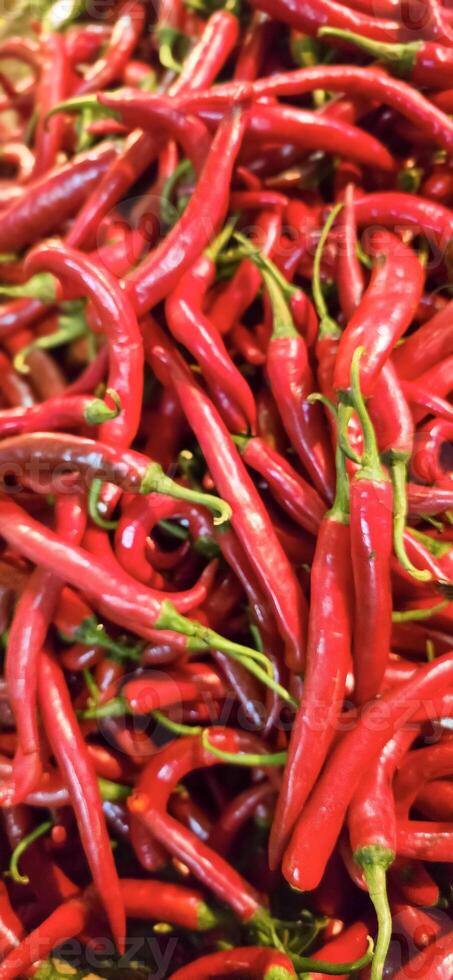 Red hot chilli peppers texture background, close up, A backdrop of Red hot chilli peppers, Street vegetable market, Group of Red hot chilli peppers photo