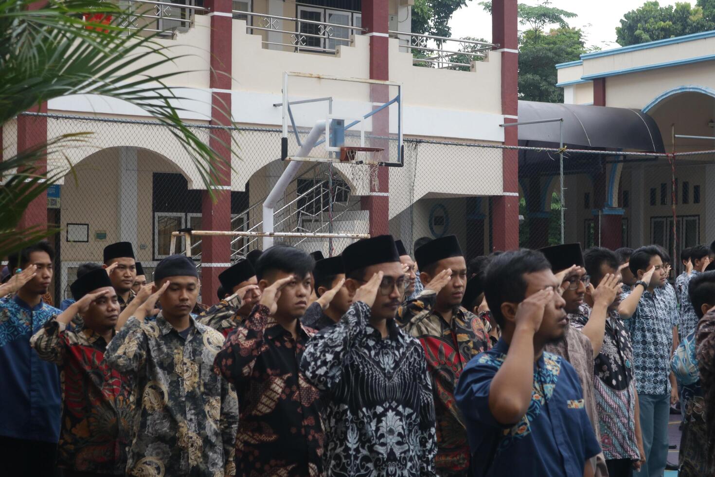 Subang, Indonesia - May 2024, Teachers are in a respectful position towards the flag during activities to commemorate National Education Day in the school field photo