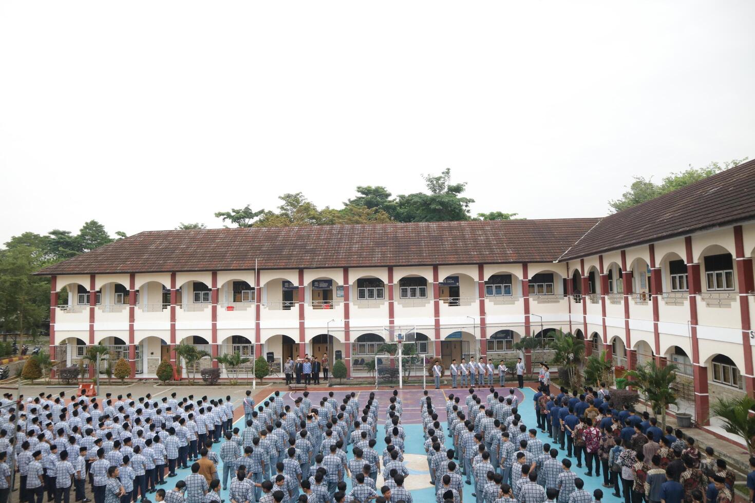 Subang, Indonesia - May 2024, Middle school, high school students and teachers taking part in a ceremony to commemorate National Education Day on the school field photo