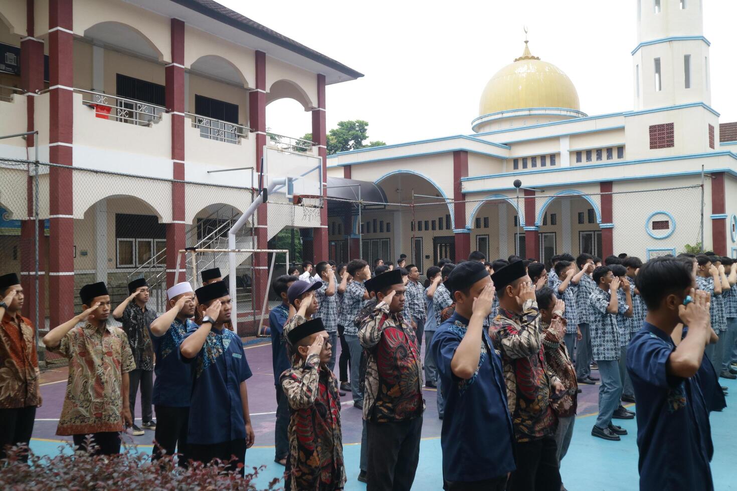 Subang, Indonesia, May 2024, Teachers are in a respectful position towards the flag during activities to commemorate National Education Day in the school field photo