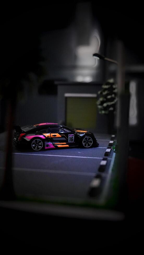 Subang, Indonesia - June 06th 2024 - Image of a scale Hotwheels hobby car model parked in a diorama. The art of die casting cars in parking dioramas. photo