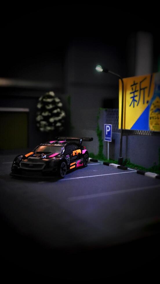 Subang, Indonesia - June 06th 2024 - Image of a scale Hotwheels hobby car model parked in a diorama. The art of die casting cars in parking dioramas. photo