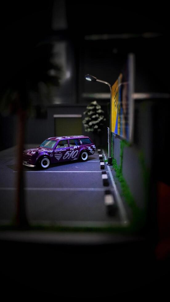 Subang, Indonesia - June 06th 2024 - Image of a scale Hotwheels hobby car model parked in a diorama. The art of die casting cars in parking dioramas. photo