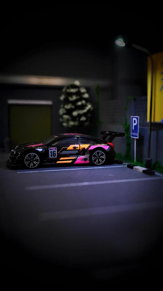 Subang, Indonesia - June 06th 2024 - Image of a scale Hotwheels hobby car model parked in a diorama. The art of die casting cars in parking dioramas. photo
