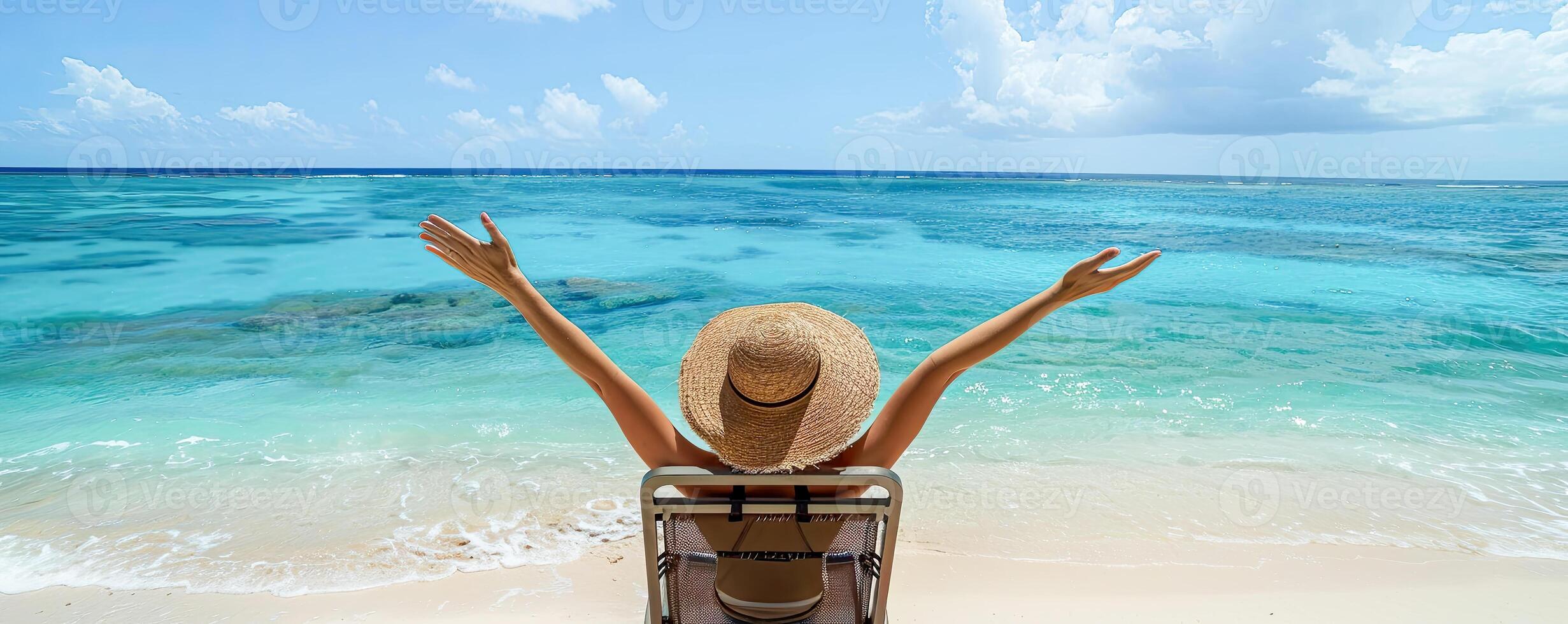Summer Vacation. Beautiful young woman raising a hand, relaxing and happy on a beach chair in holiday summer, blue sky background. Travel and lifestyle Concept photo