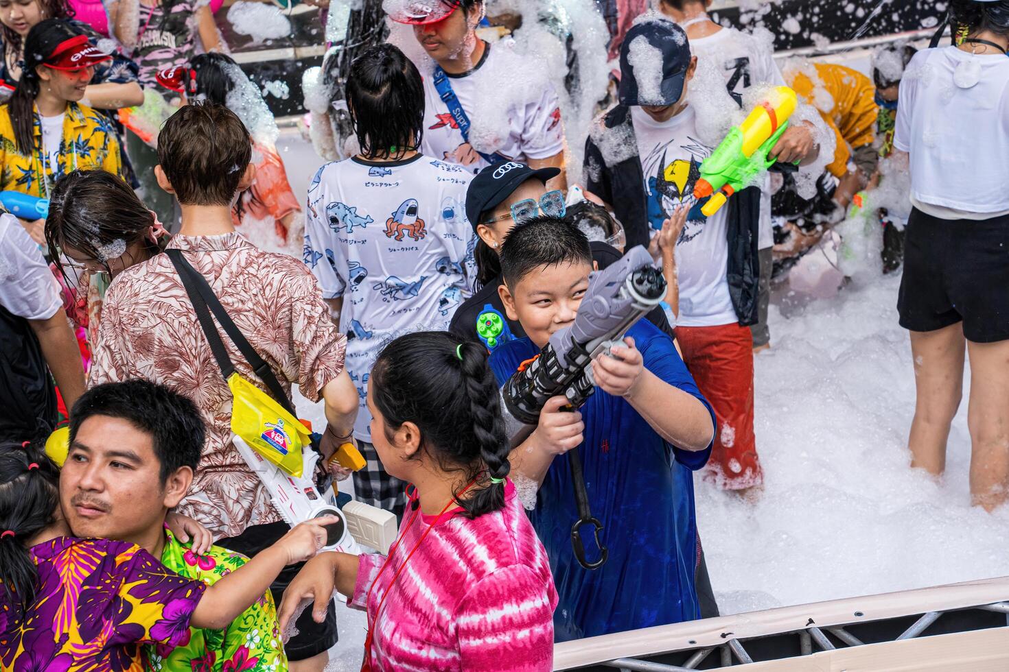 Siam Square, Bangkok, Thailand - APR 13, 2024 Songkran Festival, The short action of people joins celebrations of the Thai New Year or Songkran in Siam Square Bangkok, Thailand. photo