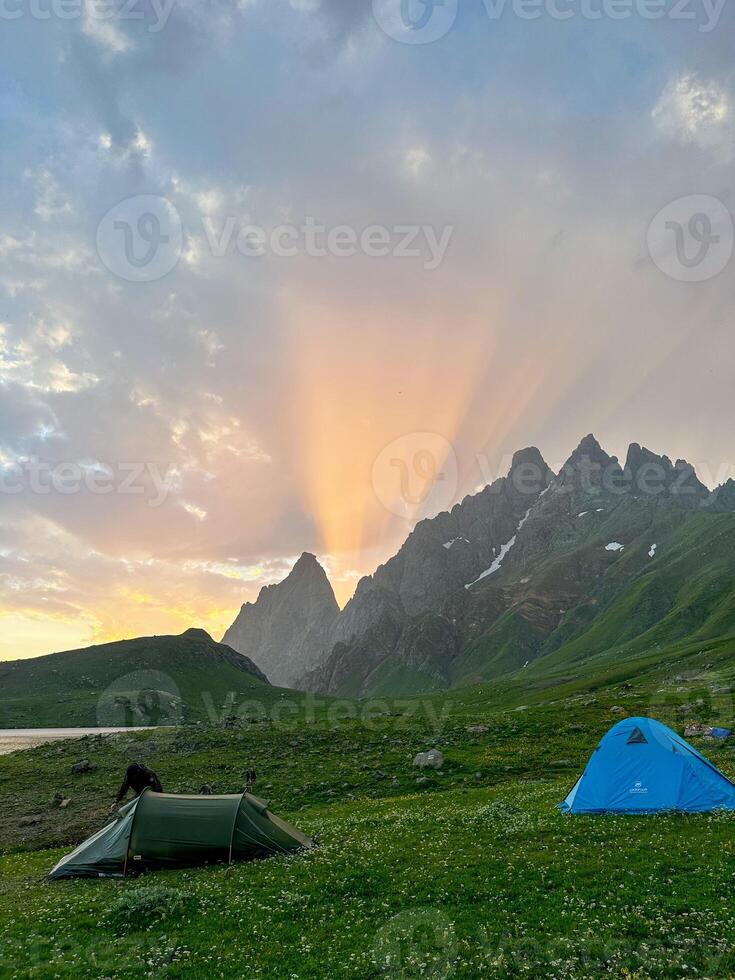 Sunset behinds the mountain and tent photo