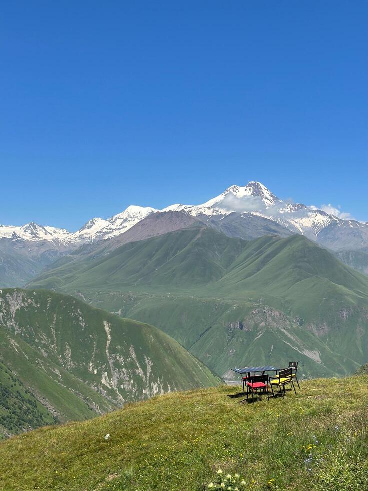 Tables set on the hill and mountain peak. photo