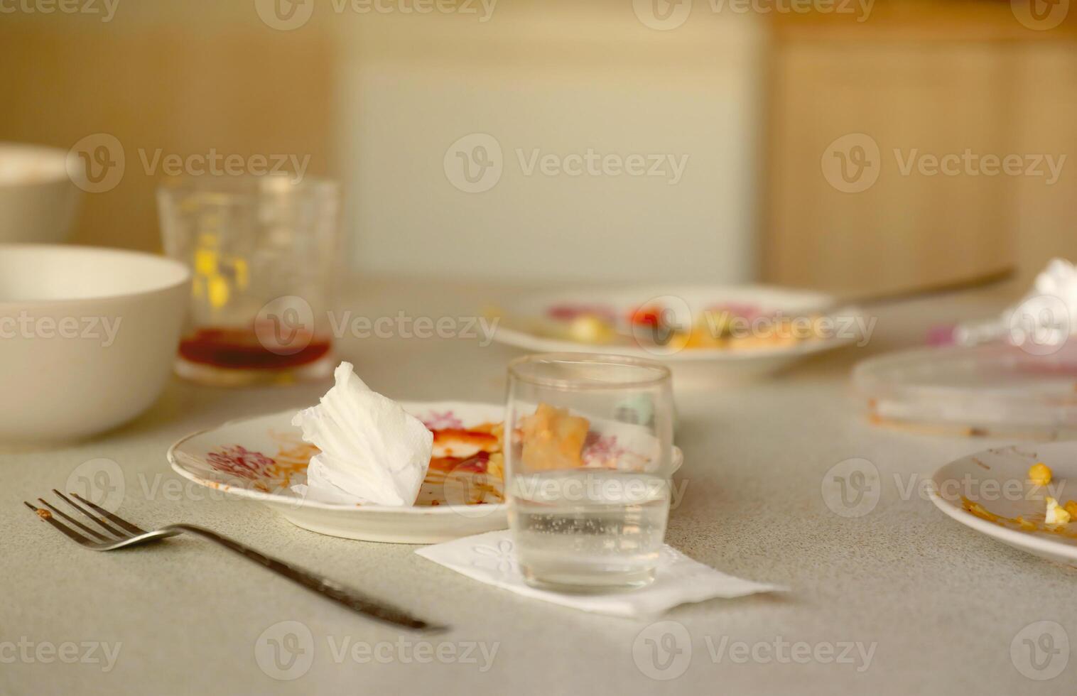 Empty dirty plates with spoons and forks on the table after meal. Banquet ending concept. Unwashed dishes photo