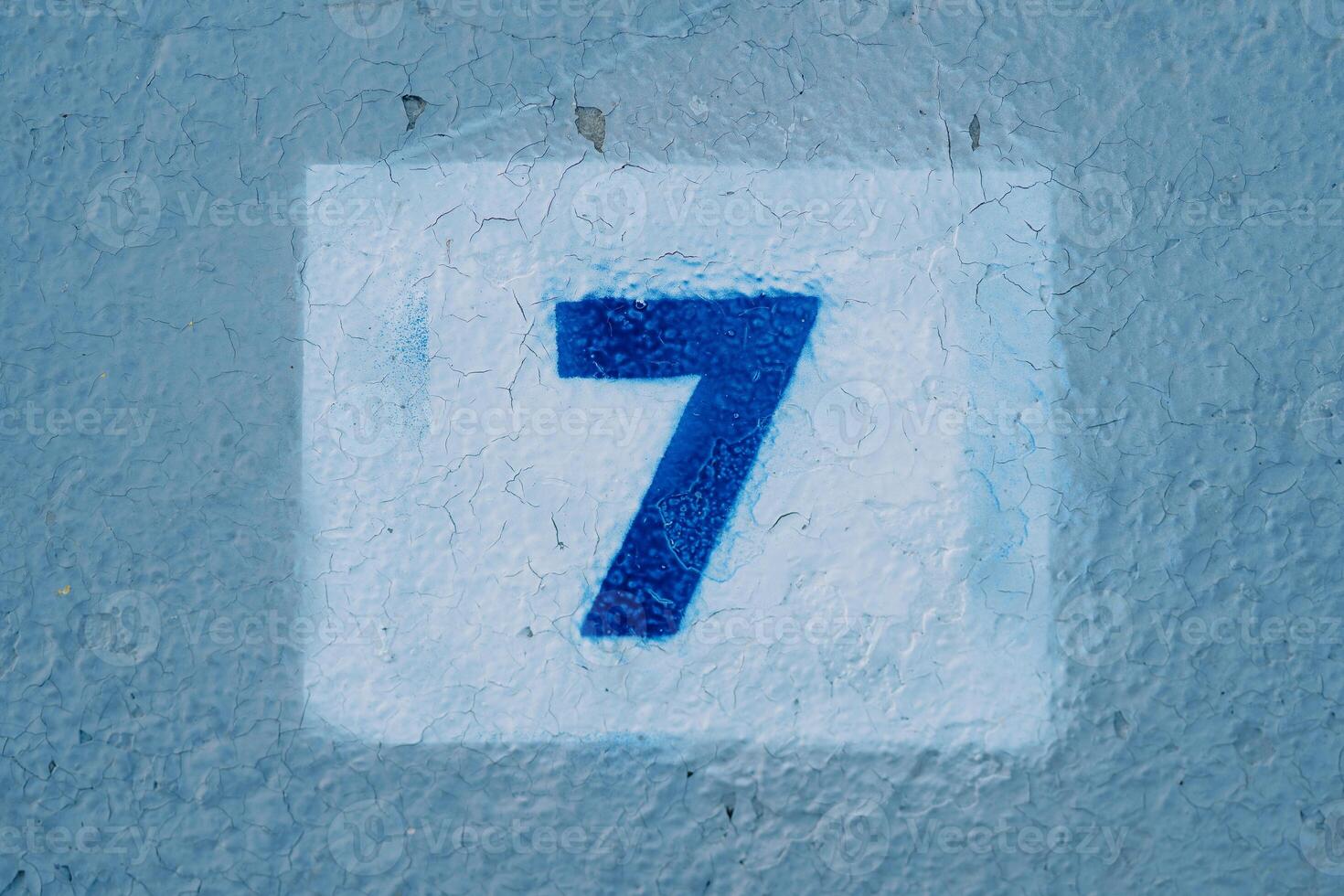 Number seven drawn on a blue wall in a rectangle photo