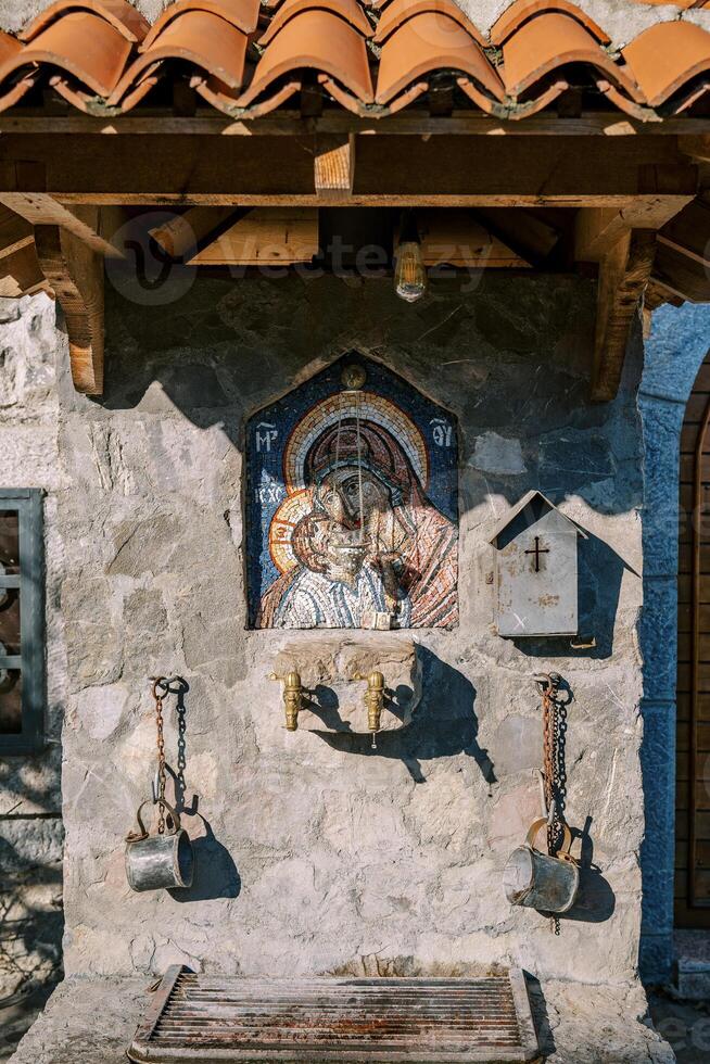 Spring of holy water and icon of the Virgin Mary in the ancient monastery of Moraca. Montenegro photo