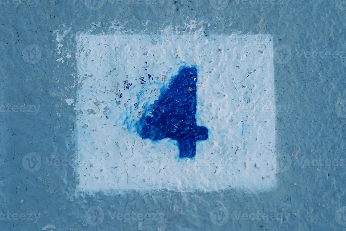 Number four with smeared paint painted on a blue wall in a rectangle photo