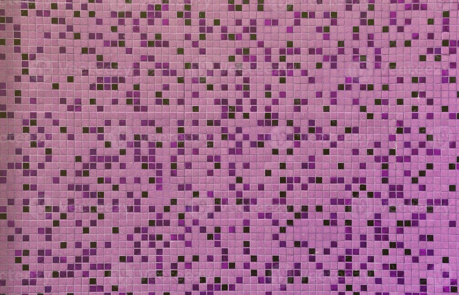 The texture of the wall, decorated with a mosaic of various small square tiles. Abstract pattern of ceramic tiles on the wall photo