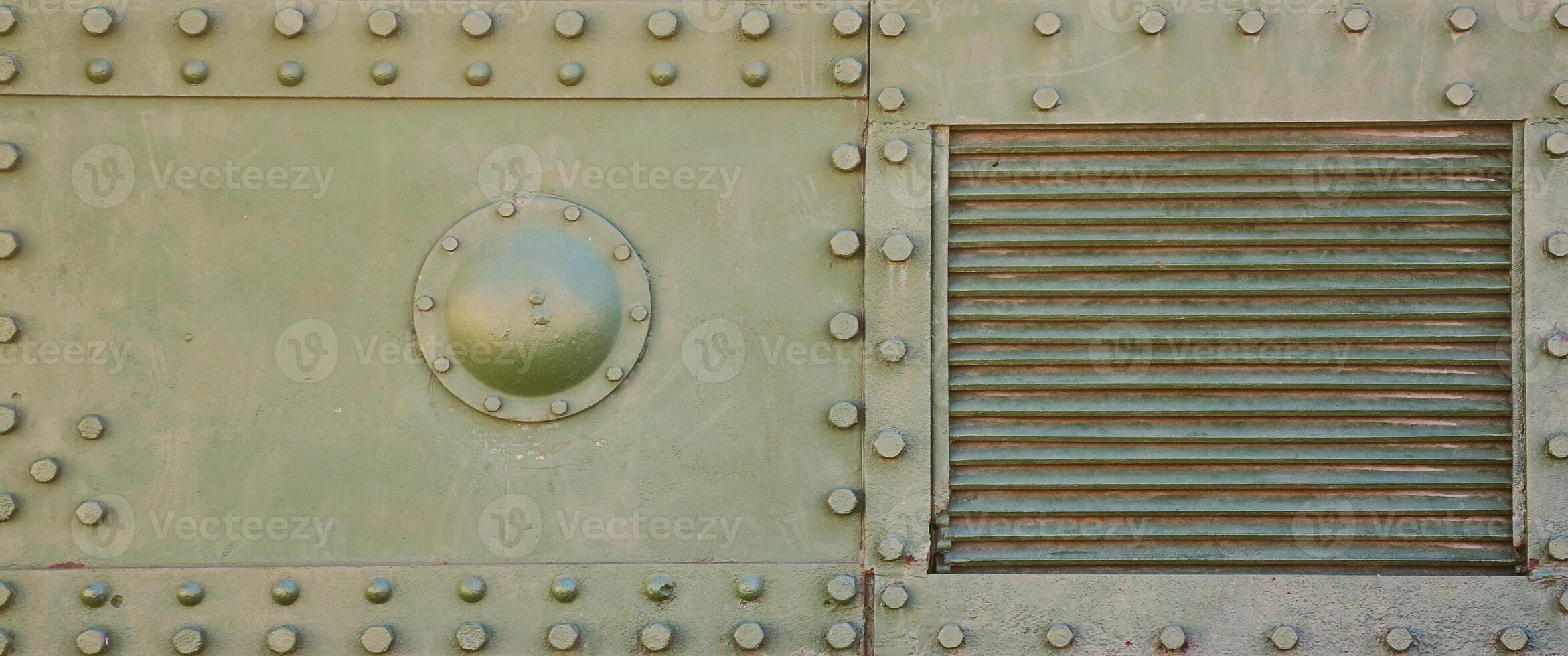 The texture of the wall of the tank, made of metal and reinforced with a multitude of bolts and rivets. Images of the covering of a combat vehicle from the Second World War photo