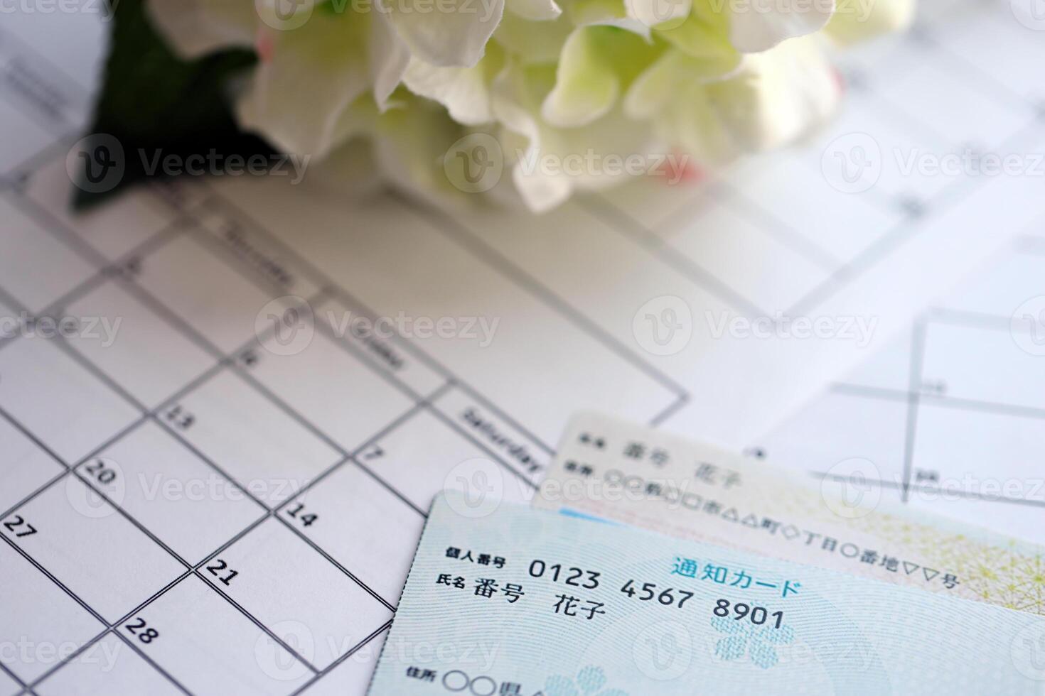 Japanese my number card specimen and notification card on calendar background photo