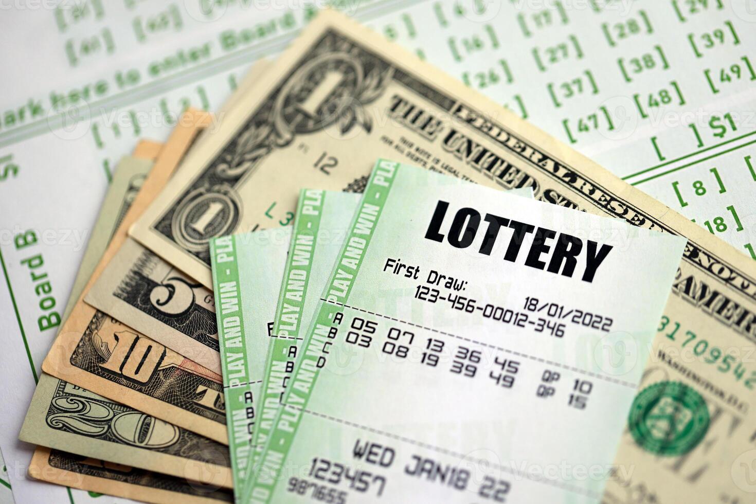 Green lottery tickets and US money bills on blank with numbers for playing lottery photo