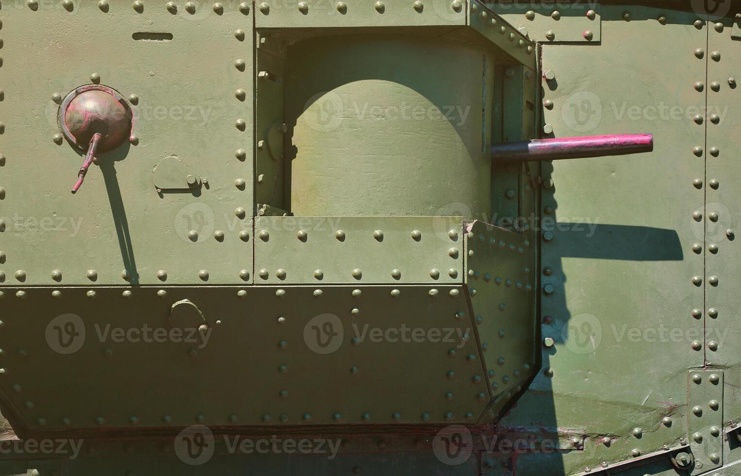The texture of the wall of the tank, made of metal and reinforced with a multitude of bolts and rivets. Images of the covering of a combat vehicle from the Second World War with a guided machine gun photo