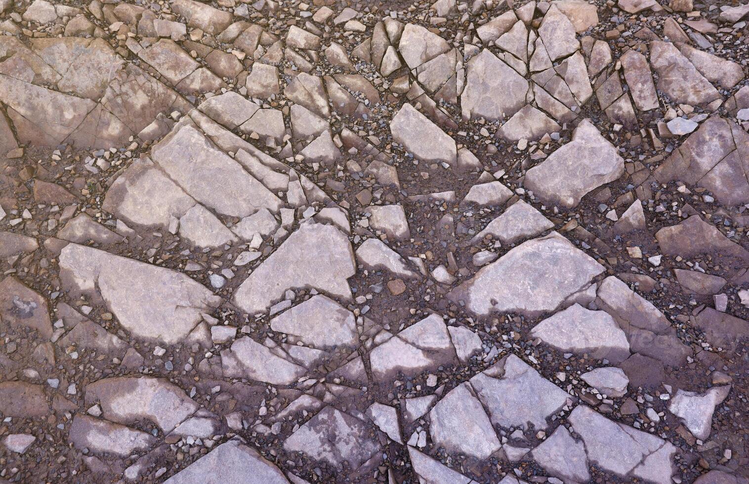 Background of shattered stony stones surface in mountain area. Texture with natural light photo