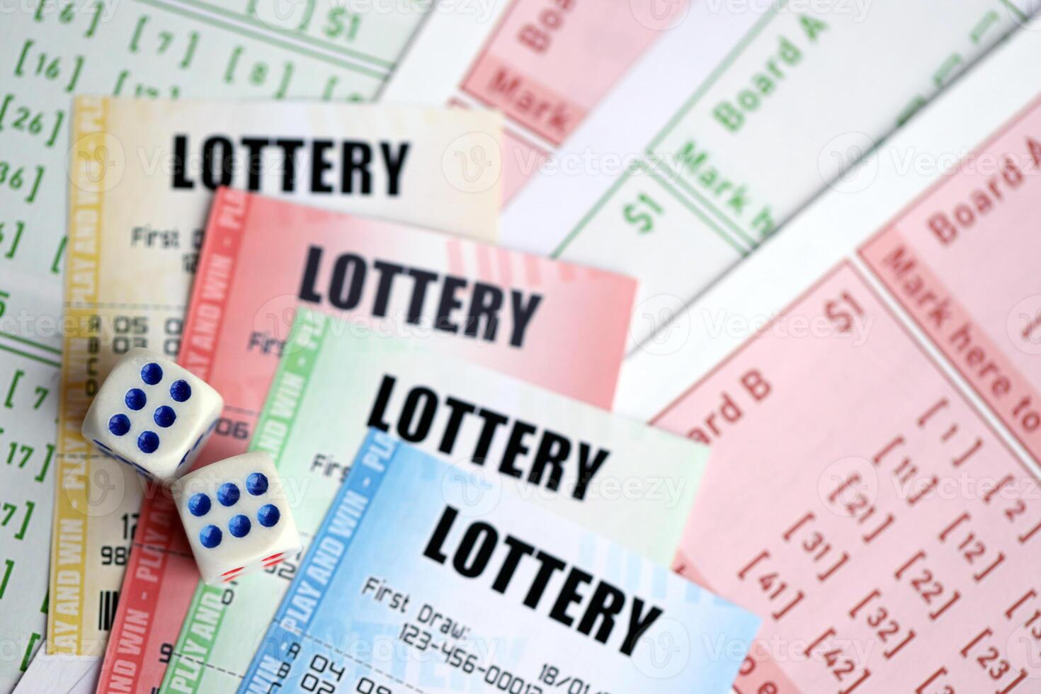 Lottery tickets of different colors and dice on blank bills with numbers for playing lottery photo